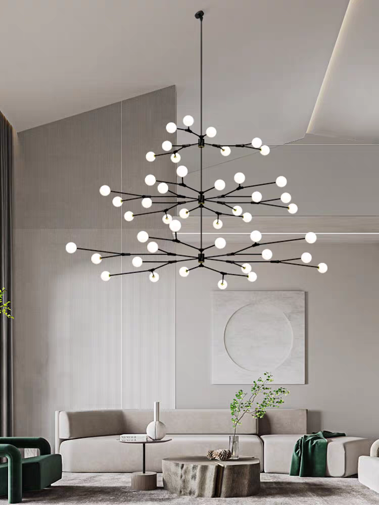The modern branch chandelier with frosted glass globes casting a warm, inviting light, viewed from a slightly lower angle.