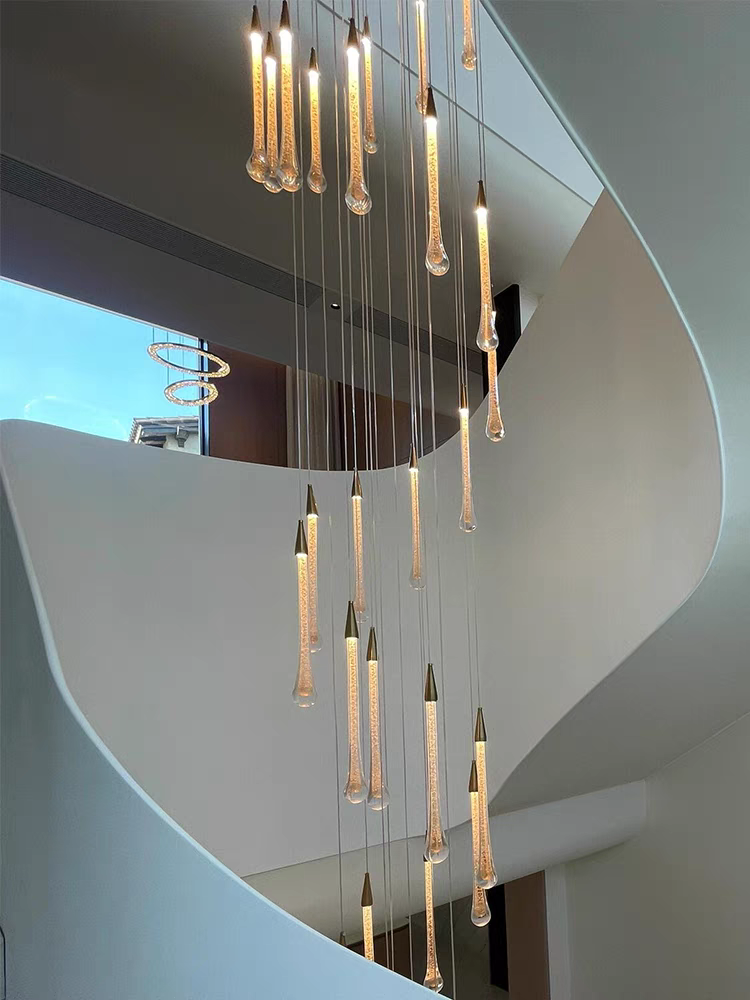 Graceful silhouette of the tiered crystal chandelier, its form evoking a gentle, frozen waterfall of light.