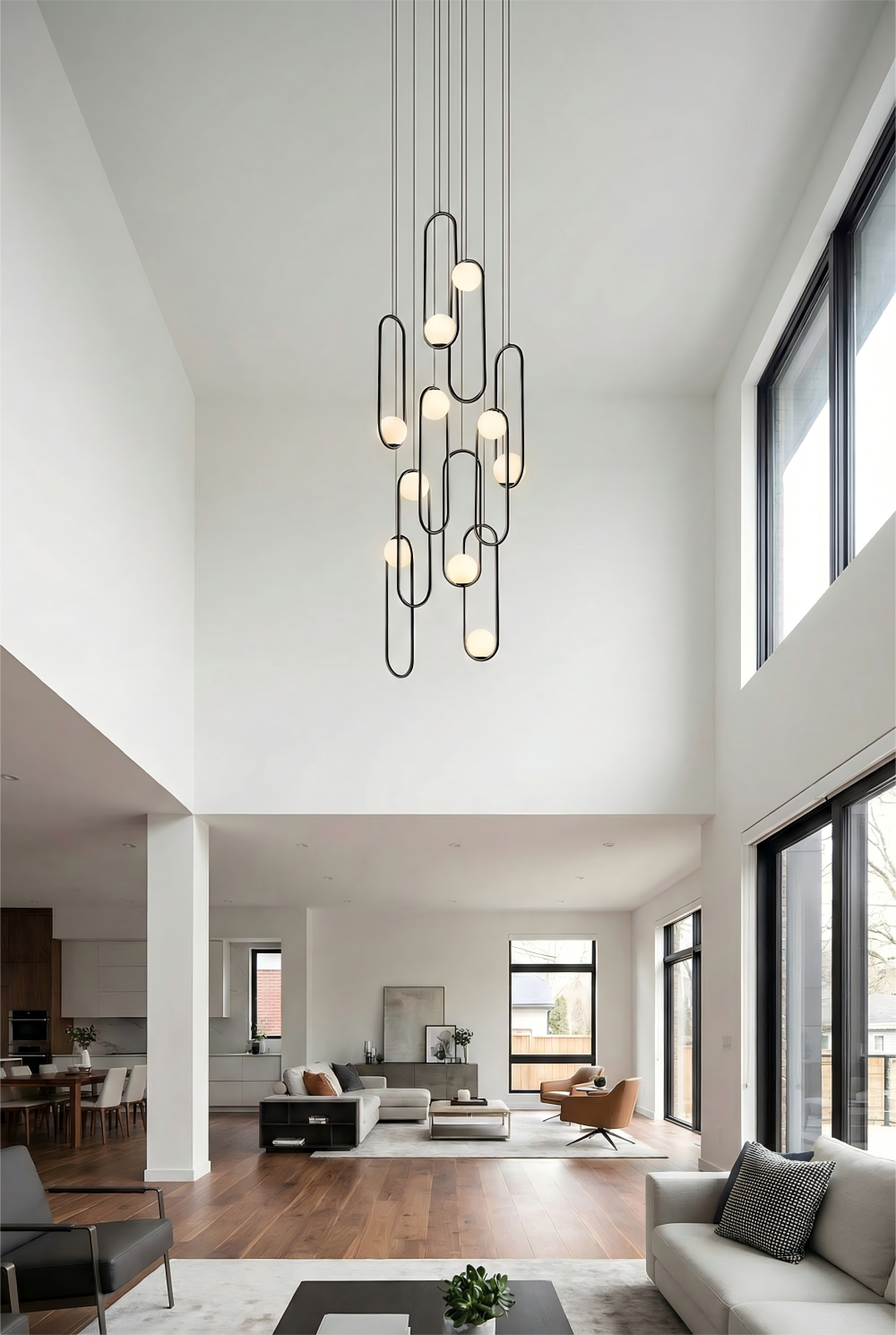 Modern living room with a stylish chandelier and large windows.