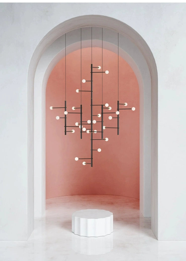 Lifestyle image of the 36-light hanging cable style chandelier in a grand entryway.