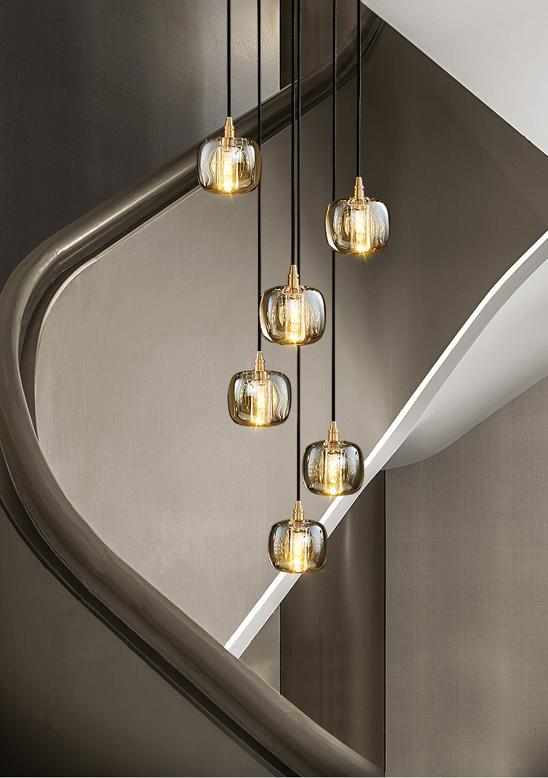 Side angle of the 6-light pendant lights, highlighting their adjustable cables and warm LED glow.