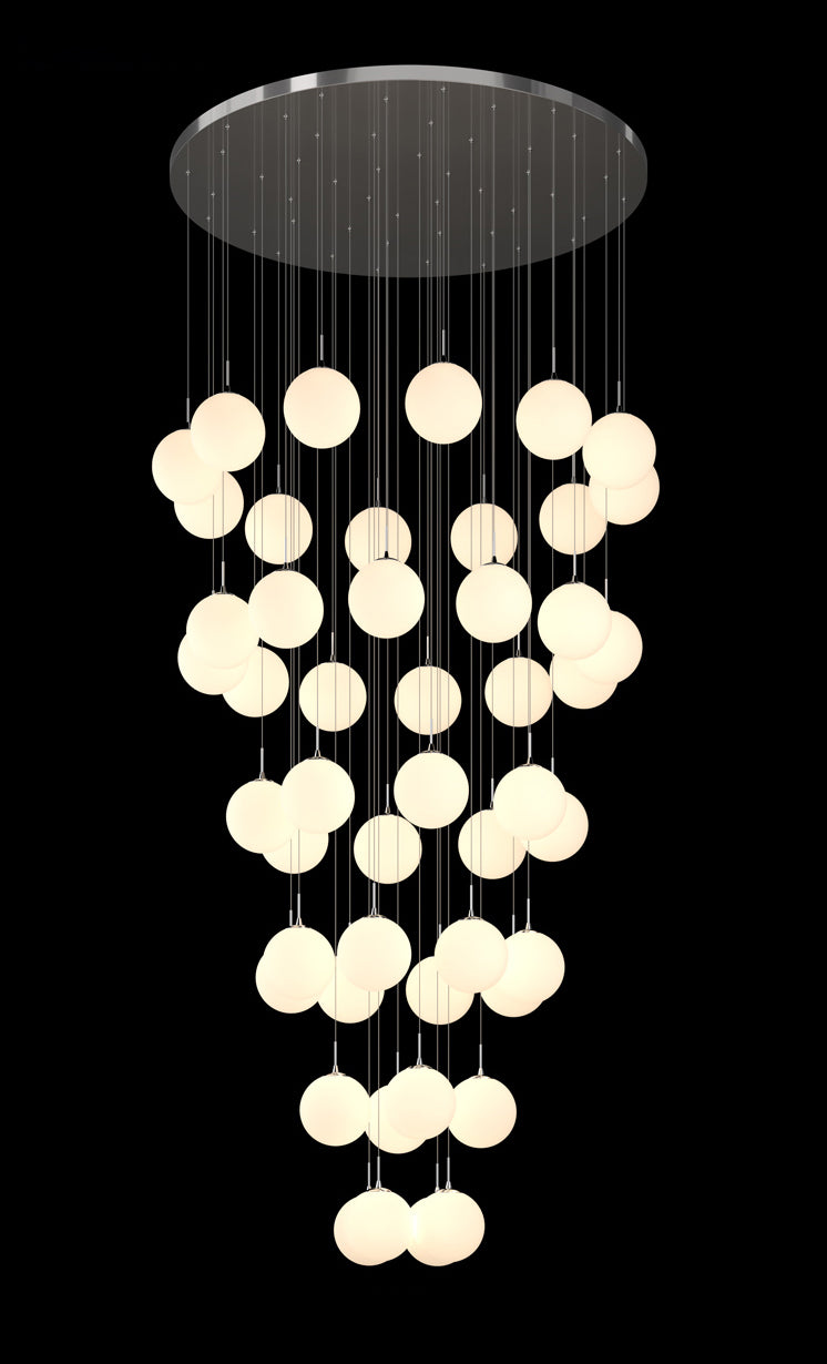 A contemporary glass globe chandelier with multiple round opal glass shades and satin metal details, hanging from a circular metal canopy.