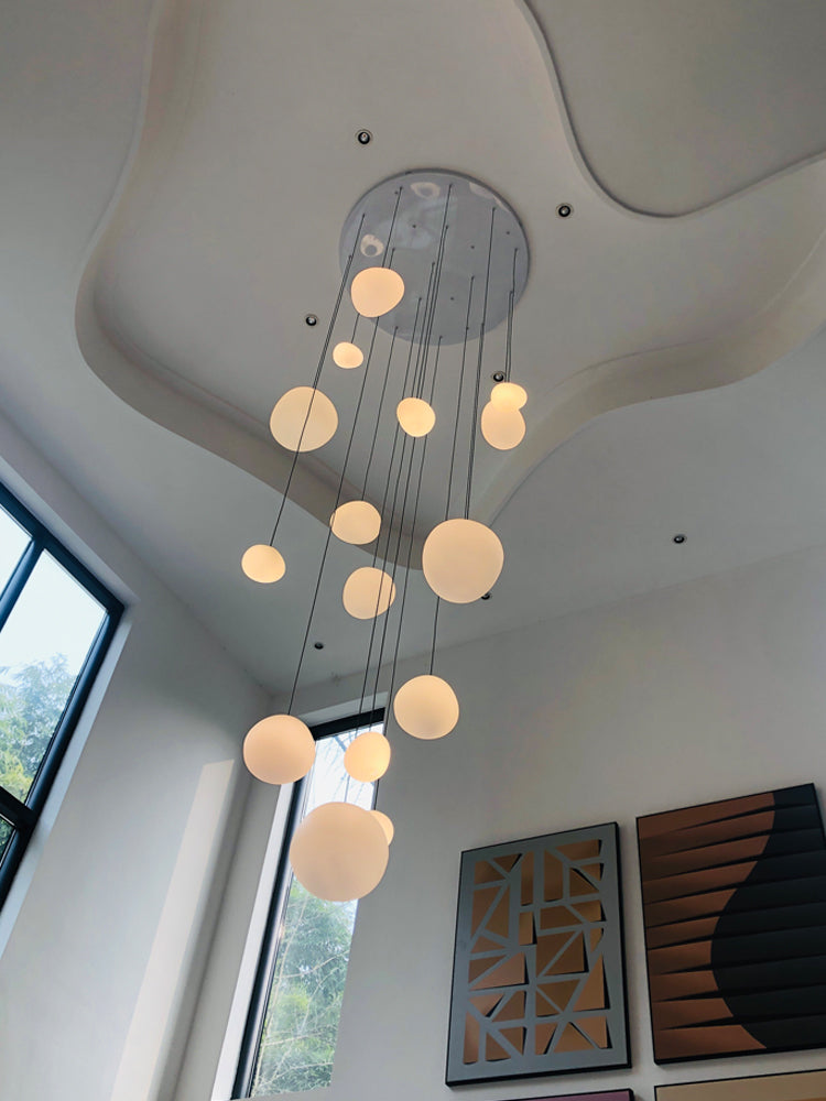 The Gregg Pendant Lamp in a grand foyer, casting a welcoming glow with its warm LED lighting.