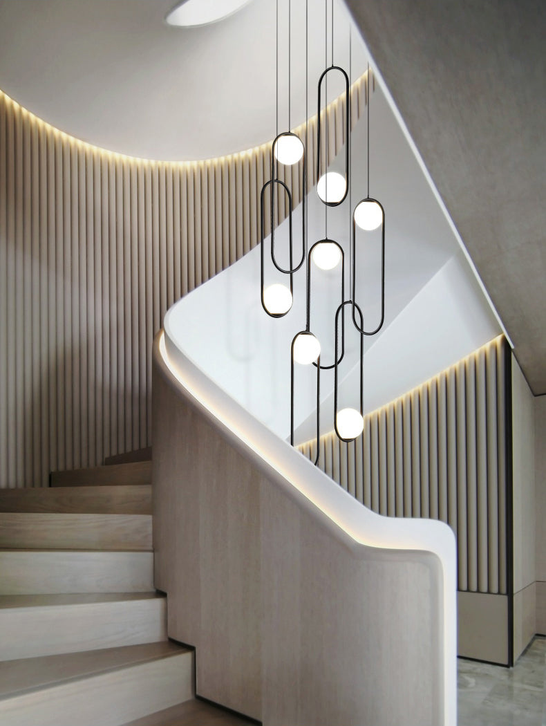 The chandelier over a staircase, adding a touch of elegance to the architectural feature with its adjustable height and sleek design.