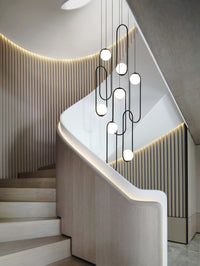 Thumbnail for The chandelier over a staircase, adding a touch of elegance to the architectural feature with its adjustable height and sleek design.