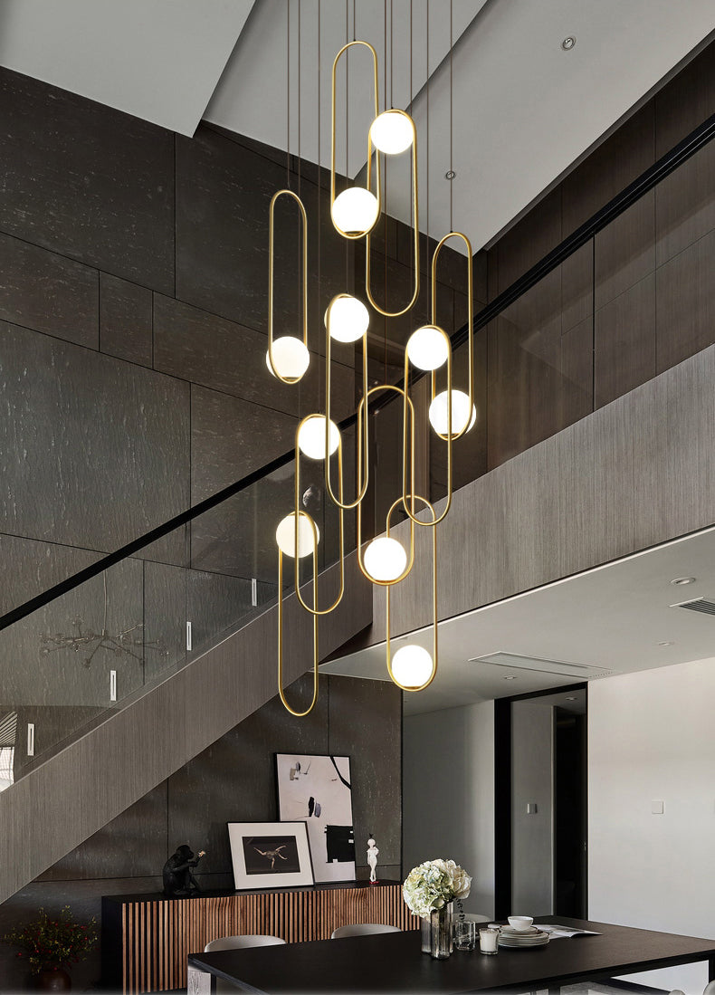 Lifestyle image of the minimalist dining room chandelier in black finish, creating a serene ambiance over a modern dining table.