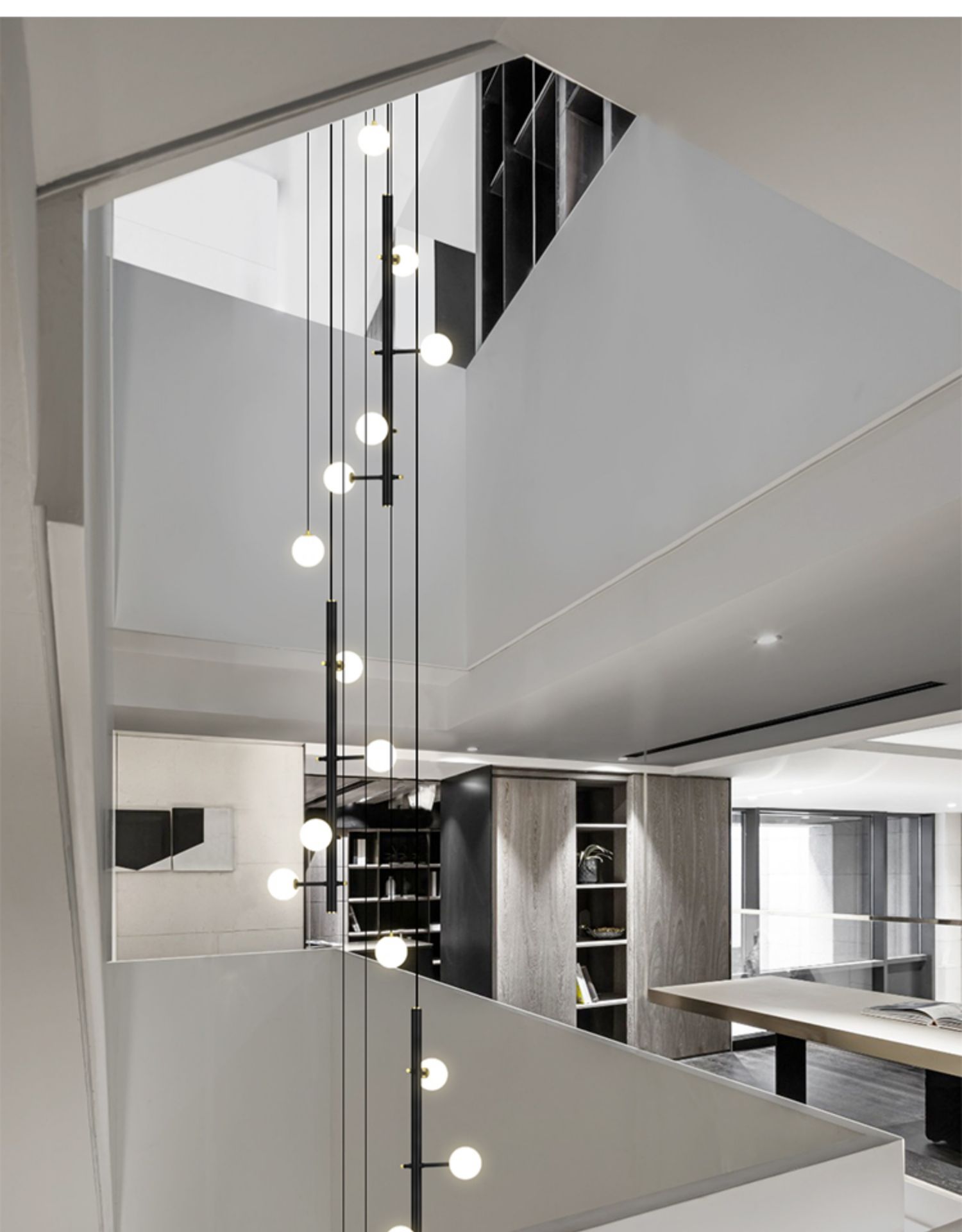 Side view of the 32-light hanging cable style chandelier on the staircase setting.