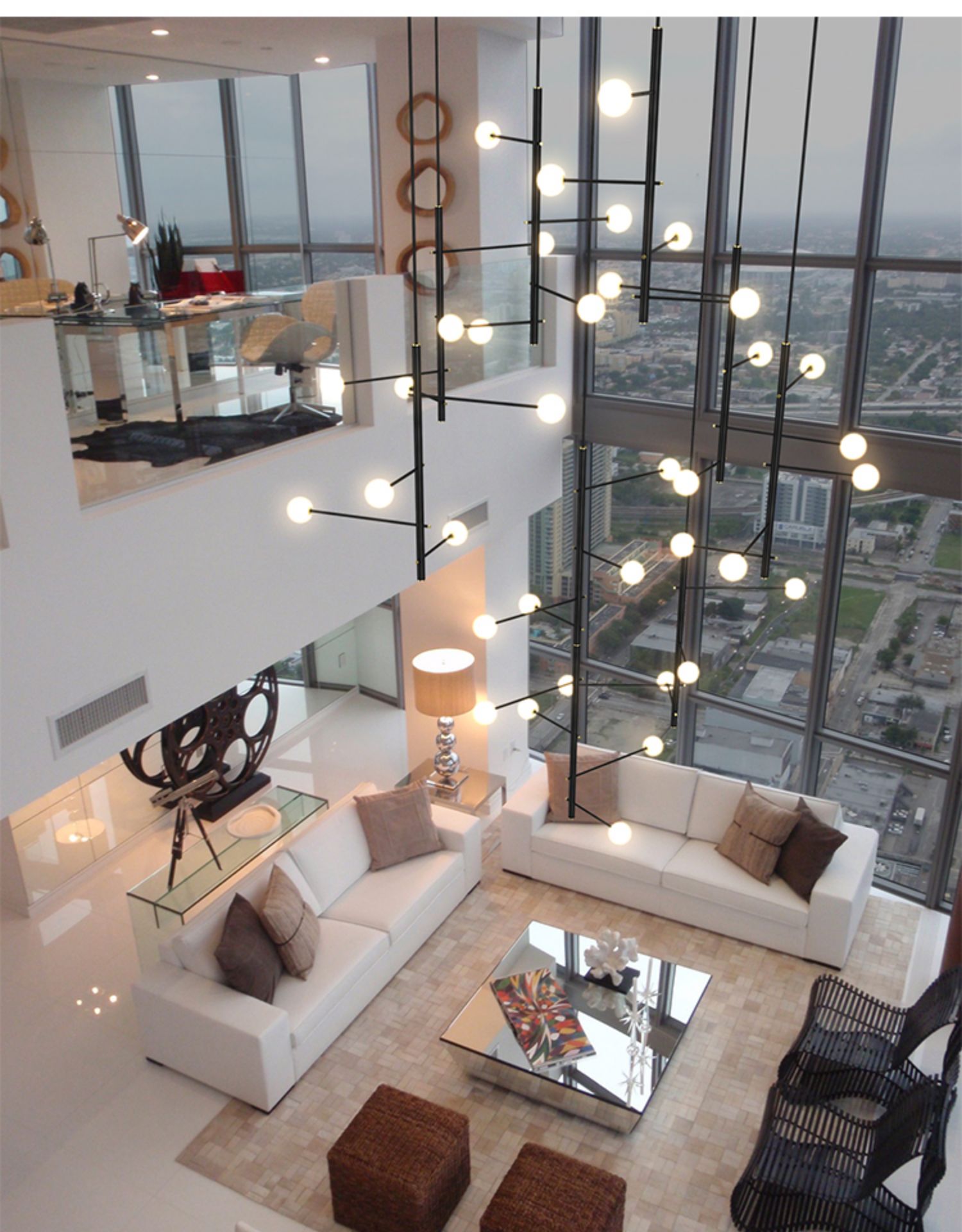 Lifestyle image of the 28-light mixed style chandelier (267 x 63 in) in a modern foyer.