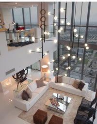 Thumbnail for Lifestyle image of the 28-light mixed style chandelier (267 x 63 in) in a modern foyer.