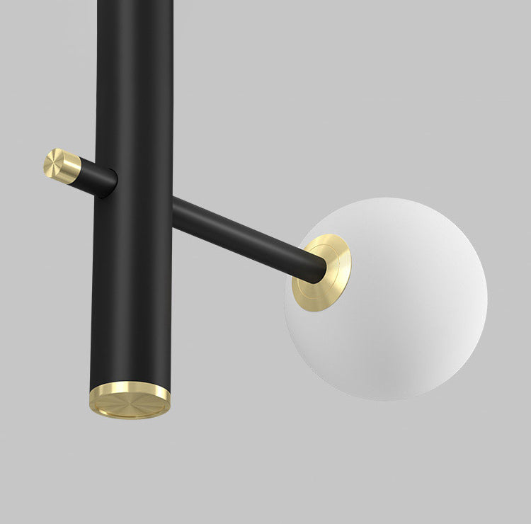 Close-up of white glass globes on the 36-light hanging cable style chandelier.