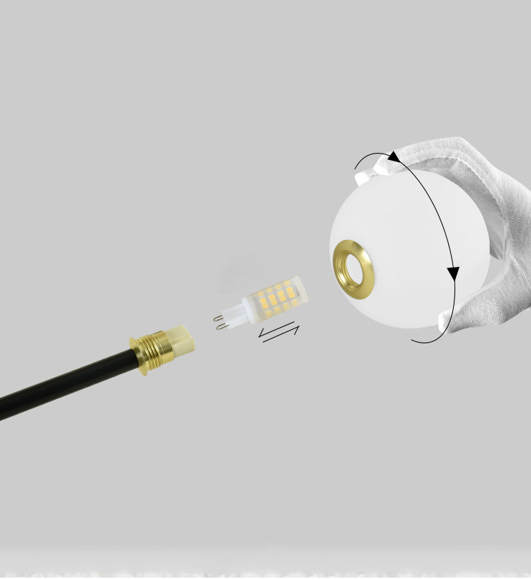 Close-up of white glass globes on the 32-light hanging cable style chandelier.