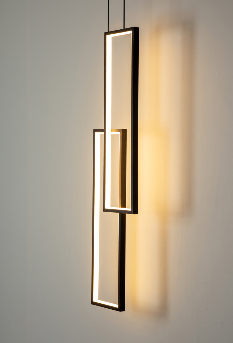 Side angle of the 2-light chandelier, highlighting its warm lighting and adjustable cables.