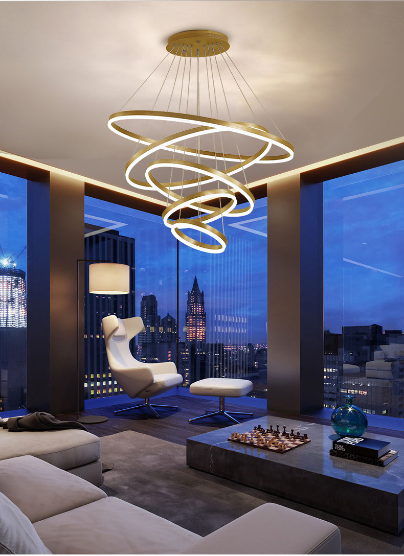 Modern circular ring chandelier with LED lights hanging in a room with large windows, providing a sophisticated tone.