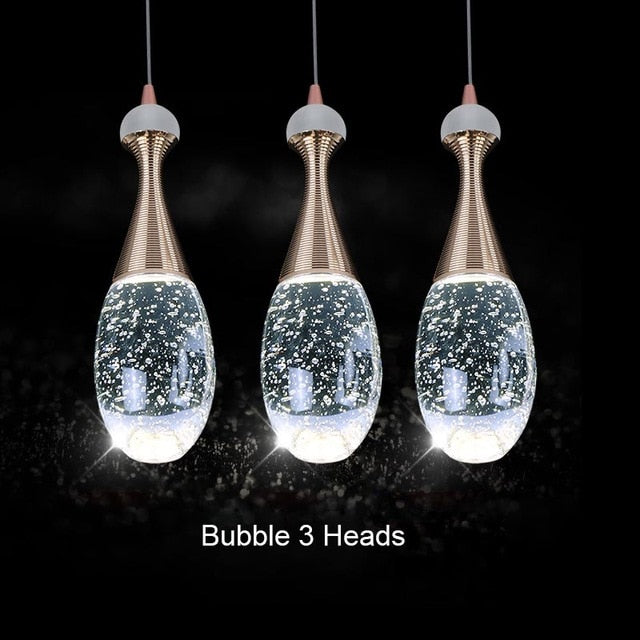 clear glass pendant light over dinning table