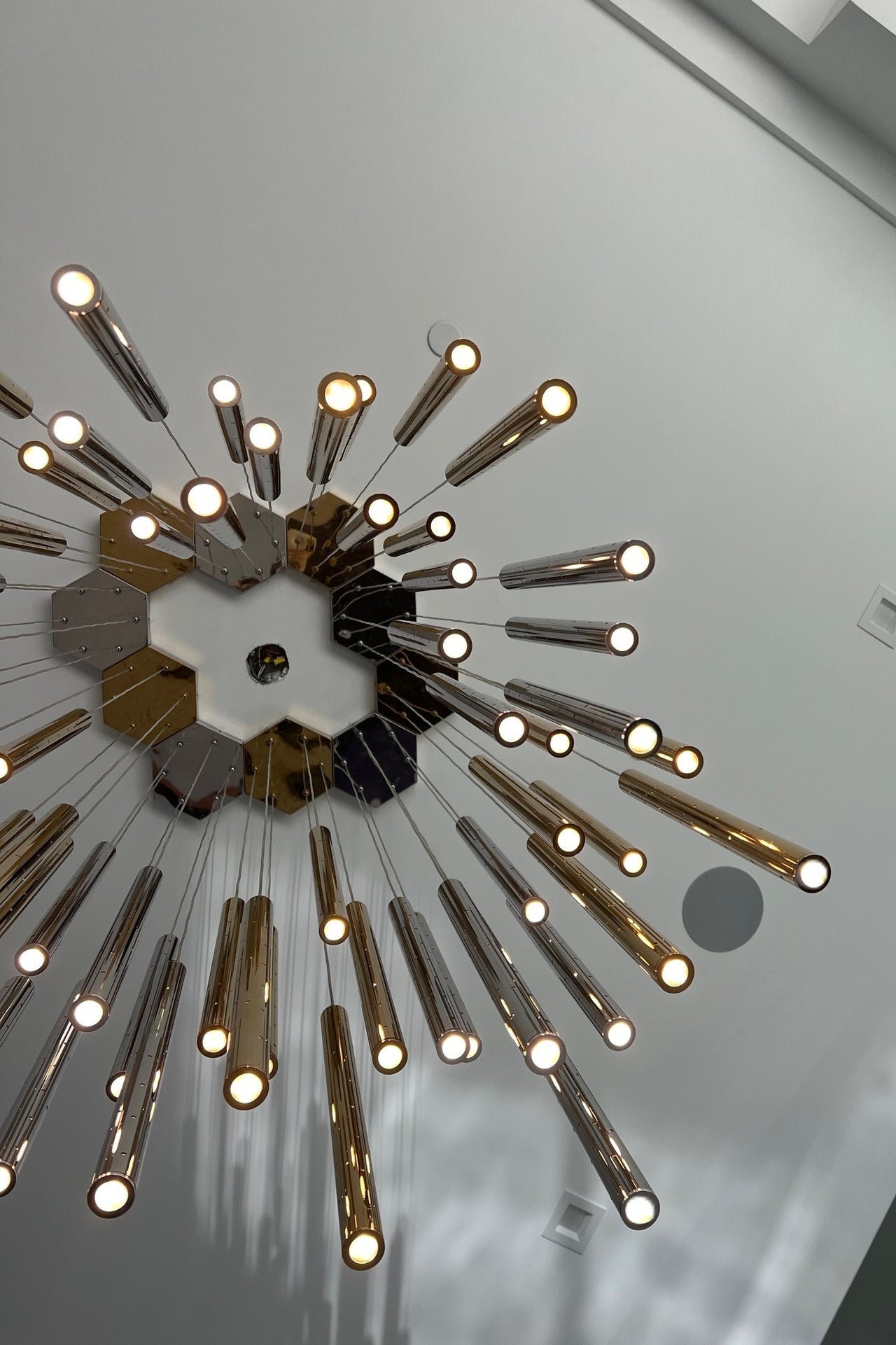 Lifestyle image of the chandelier in a grand foyer, radiating romantic elegance.