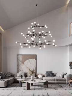 In a lifestyle setting, the Branches Chandelier graces a modern living room with a warm, inviting light.