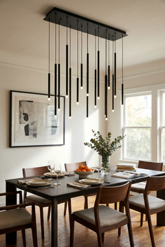 Dining room with modern black pendant light fixture, table set for dinner, and abstract art on the wall.