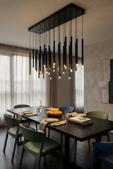 Modern dining room with a stylish chandelier, table, and chairs.