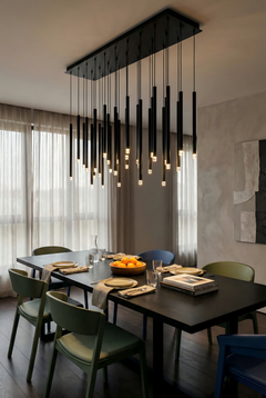 Modern dining room with a stylish chandelier, table, and chairs.