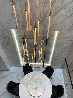 The ambient effect of the celestial chandelier, casting soft, patterned light that enhances architectural details.