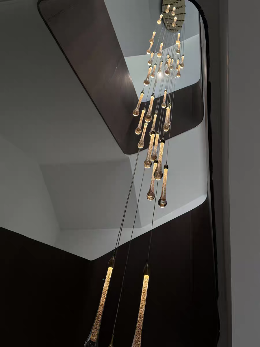 A captivating view upwards into the heart of the celestial chandelier, revealing its harmonious, multi-tiered crystal structure.