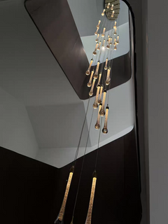 A captivating view upwards into the heart of the celestial chandelier, revealing its harmonious, multi-tiered crystal structure.