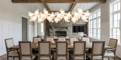 Modern dining room with a long wooden table and chairs, large pendant light fixture, and large windows.