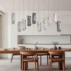 Lifestyle image of the Frosted Glass Chandelier installed in a sophisticated dining room, casting a warm, inviting light over the table.