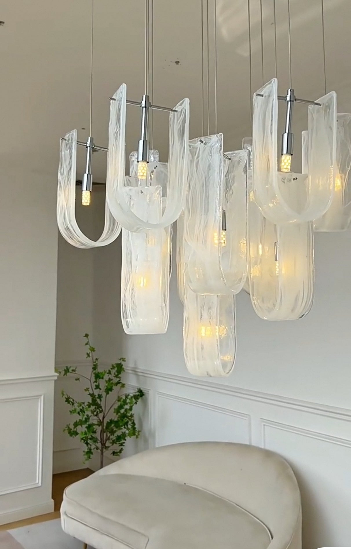 Nebula Wave Chandelier enhancing a cozy bedroom ambiance with soft, inviting light