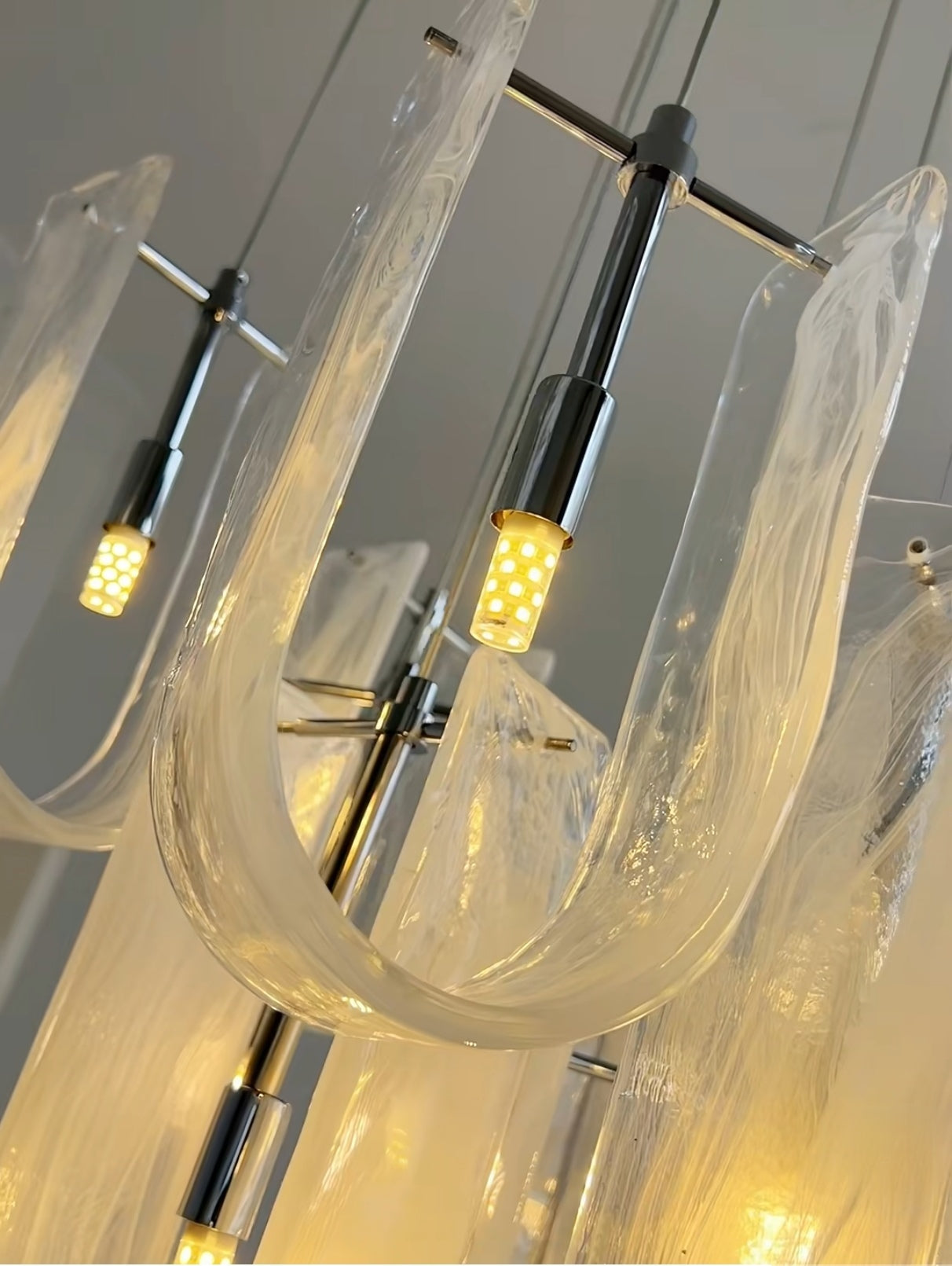 LED bulbs installed in Nebula Wave Chandelier, providing energy-efficient warm white light