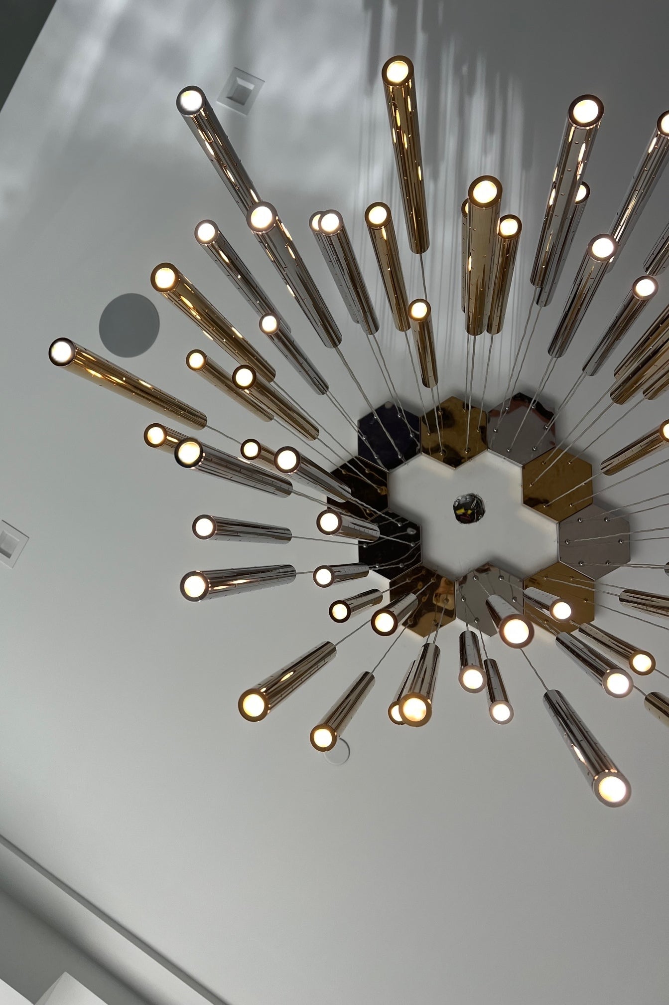 Top view of Aurorae Shop’s Sparkling Long Cylindrical Chandelier, showcasing chrome cylinders and sparkling light effect.
