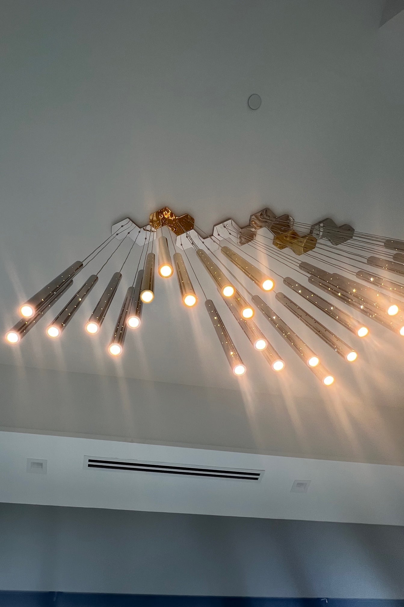 Fully lit chandelier image, highlighting its vibrant, star-like illumination.