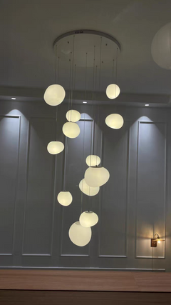 Atmospheric shot of the Luminous Pebble pendant creating a calm and inviting glow in an evening setting.