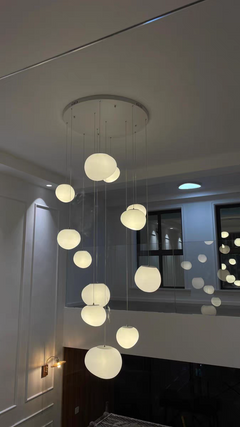 Elegant simplicity of the Luminous Pebble pendant design against a clean, modern backdrop.
