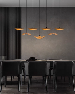 In a lifestyle setting, the Wooden Shade Chandelier graces a modern dining room with a warm, inviting light.