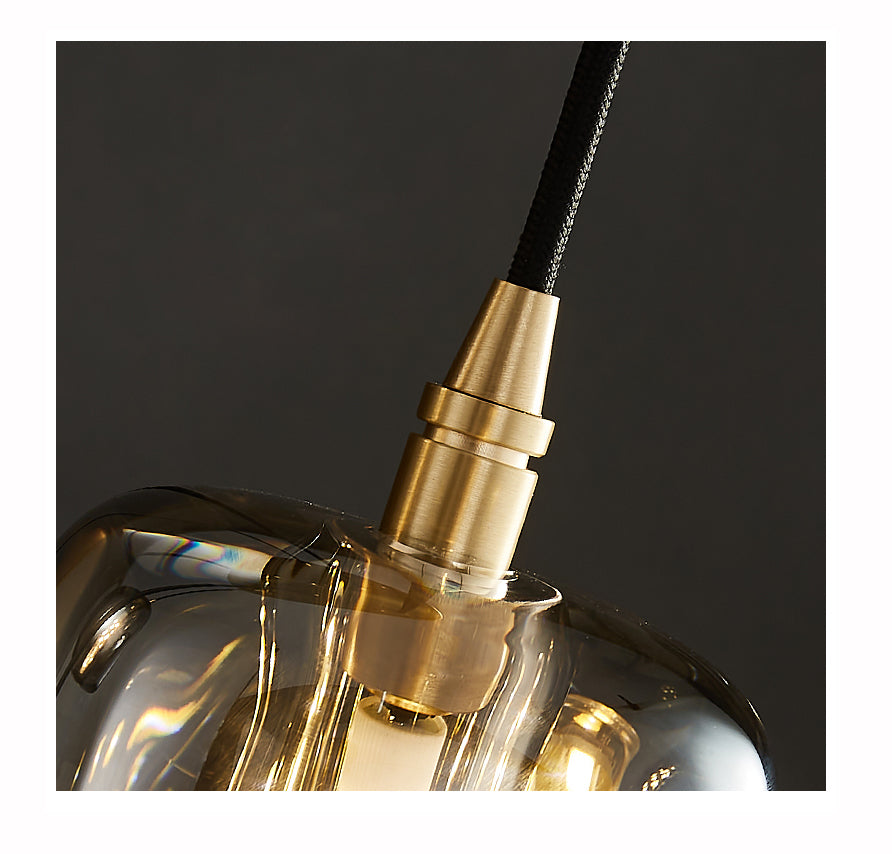 Close-up detail of the crystal rods and polished brass frame of the Luminous Column pendant.