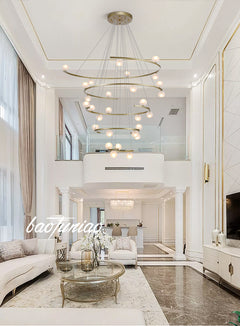 Lifestyle image of the 28-light chandelier in a modern foyer, casting a radiant glow.