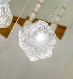 Close-up of a mouth-blown glass shade, revealing its stone-inspired texture and light diffusion.