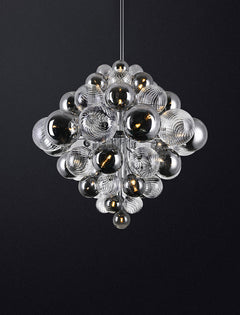 Dimmed lighting view of the 25-light chandelier, creating a warm, intimate atmosphere.