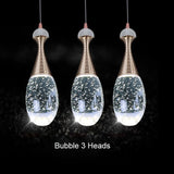clear glass pendant light over dinning table